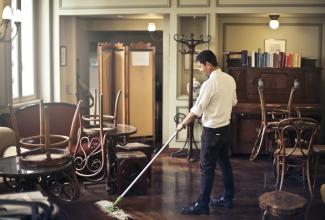 Man cleaning floor in restaurant