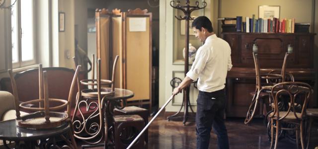 Man cleaning floor in restaurant